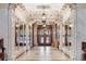 Impressive foyer featuring marble columns, mirrored walls, and ornate ceiling details at 836 E 17Th Ave # 1A, Denver, CO 80218