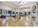 Spacious gym featuring hardwood floors, columns, and an array of exercise equipment at 836 E 17Th Ave # 1A, Denver, CO 80218