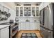 Contemporary kitchen with white cabinets, subway tile backsplash, and stainless steel refrigerator at 836 E 17Th Ave # 1A, Denver, CO 80218
