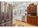 Cozy kitchen featuring stainless steel appliances, white cabinets, and decorative stained glass windows at 836 E 17Th Ave # 1A, Denver, CO 80218