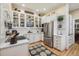 Bright kitchen with white cabinets, subway tile backsplash, and stainless steel appliances at 836 E 17Th Ave # 1A, Denver, CO 80218