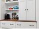 Close up of a kitchen with white cabinets, stainless steel appliances, and a coffee bar at 836 E 17Th Ave # 1A, Denver, CO 80218