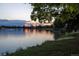 Scenic view of a serene lake at sunset, surrounded by trees and greenery at 836 E 17Th Ave # 1A, Denver, CO 80218