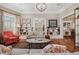 Open-concept living room with hardwood floors, a gray sofa, and a red accent chair at 836 E 17Th Ave # 1A, Denver, CO 80218