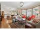 Bright living room with hardwood floors, fireplace, and large windows at 836 E 17Th Ave # 1A, Denver, CO 80218