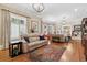 Inviting living room featuring hardwood floors and large windows with shutters at 836 E 17Th Ave # 1A, Denver, CO 80218