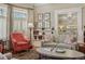 Inviting living room featuring a comfortable gray sofa, red accent chair, and stylish decor at 836 E 17Th Ave # 1A, Denver, CO 80218