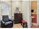 Charming office nook with a dark wood secretary, comfortable chair, and lots of natural light from a unique window at 836 E 17Th Ave # 1A, Denver, CO 80218