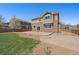 Back of house with a grass yard and concrete patio, next to a gravel section and wood fence at 6786 Halifax Ave, Castle Rock, CO 80104