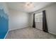 Bedroom featuring neutral carpet, ceiling fan and window with decorative mountain-scene painted accent wall at 6786 Halifax Ave, Castle Rock, CO 80104