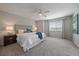 Spacious primary bedroom with ceiling fan, carpet, and a large window at 6786 Halifax Ave, Castle Rock, CO 80104