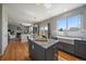 Open concept kitchen with hardwood floors, granite counters, stainless appliances, and seamless flow to living areas at 6786 Halifax Ave, Castle Rock, CO 80104