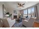 Cozy living room with hardwood floors, a fireplace, large windows, and contemporary stylish furnishings at 6786 Halifax Ave, Castle Rock, CO 80104