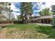 A large backyard with mature trees, a well-kept lawn, and a patio, perfect for outdoor entertaining at 6211 S Garfield Dr, Centennial, CO 80121