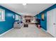 Cozy basement featuring a brick fireplace, built-in shelving and blue walls at 6211 S Garfield Dr, Centennial, CO 80121