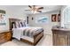 Cozy bedroom featuring a wood-framed bed, ceiling fan and natural light at 6211 S Garfield Dr, Centennial, CO 80121