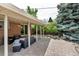 Charming covered patio with views of the spacious backyard and mature trees at 6211 S Garfield Dr, Centennial, CO 80121