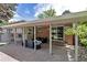Inviting covered patio area with brick pillars and a manicured backyard at 6211 S Garfield Dr, Centennial, CO 80121