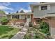 Charming front entrance of the home with brick accents and steps leading to the front door at 6211 S Garfield Dr, Centennial, CO 80121