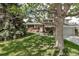 Charming two-story home with brick accents, lush lawn, mature trees and manicured landscaping at 6211 S Garfield Dr, Centennial, CO 80121