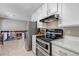 Bright kitchen featuring stainless steel appliances, white cabinetry, and an adjacent dining area at 6211 S Garfield Dr, Centennial, CO 80121
