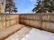 Small fenced backyard with patio and snow at 8019 Wolff St # H, Westminster, CO 80031