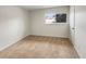 Simple bedroom with neutral walls, carpeting, and a window with a view at 8019 Wolff St # H, Westminster, CO 80031