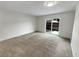 Bright living room with carpet and sliding glass door at 8019 Wolff St # H, Westminster, CO 80031