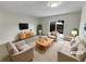 Virtually staged living room featuring modern furniture and sliding glass doors at 8019 Wolff St # H, Westminster, CO 80031