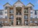 Exterior view of a well-maintained apartment building, showcasing its stone accents and balconies at 7292 S Blackhawk St # 2-306, Englewood, CO 80112