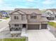 Stunning aerial view of a two-story home with a large driveway and a beautifully landscaped yard at 2040 Rosette Pl, Castle Rock, CO 80104