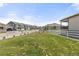 Beautifully landscaped backyard with lush green grass, fenced perimeter, and community views at 2040 Rosette Pl, Castle Rock, CO 80104