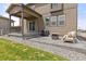 Back patio with grill and comfortable chair, perfect for relaxing and outdoor cooking at 2040 Rosette Pl, Castle Rock, CO 80104