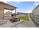 Cozy backyard patio area with a grill, picnic table, and view of the neighborhood at 2040 Rosette Pl, Castle Rock, CO 80104