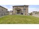 Spacious backyard with well-maintained lawn and outdoor patio area for entertaining at 2040 Rosette Pl, Castle Rock, CO 80104
