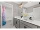 Clean bathroom with a double sink vanity, neutral walls, and a tub-shower combo with mermaid shower curtain at 2040 Rosette Pl, Castle Rock, CO 80104
