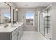Modern bathroom with double sink vanity, sleek mirrors, and a glass-enclosed shower showcasing modern fixtures at 2040 Rosette Pl, Castle Rock, CO 80104