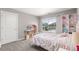 Bright bedroom with a large window, playful decor, and comfortable carpet flooring at 2040 Rosette Pl, Castle Rock, CO 80104