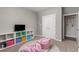 Cozy bedroom with neutral tones, playful decor, and plenty of storage space at 2040 Rosette Pl, Castle Rock, CO 80104