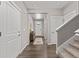 Bright entryway featuring hardwood floors, neutral paint, and access to the staircase at 2040 Rosette Pl, Castle Rock, CO 80104