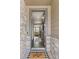 Inviting foyer with wood floors, stone accents, and a view into the living area at 2040 Rosette Pl, Castle Rock, CO 80104