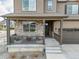 Inviting front porch with stone accents and cozy seating, perfect for relaxing outdoors at 2040 Rosette Pl, Castle Rock, CO 80104