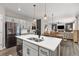View of the kitchen shows island with seating and access to the dining and living rooms at 2040 Rosette Pl, Castle Rock, CO 80104