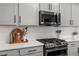 Kitchen features granite countertops, modern appliances and white subway tile backsplash at 2040 Rosette Pl, Castle Rock, CO 80104