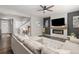 Bright living room features a fireplace, modern ceiling fan and stylish decor at 2040 Rosette Pl, Castle Rock, CO 80104