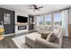 Bright living room has a gray wall, large windows, white blinds and a fireplace at 2040 Rosette Pl, Castle Rock, CO 80104