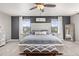 Beautiful main bedroom with ceiling fan, gray walls, and natural light from dual windows on either side of the bed at 2040 Rosette Pl, Castle Rock, CO 80104