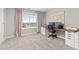 Bright home office with a large window, built-in desk, and cozy carpet flooring at 2040 Rosette Pl, Castle Rock, CO 80104