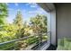This outdoor balcony with steel railing offers beautiful views of the green space and trees at 2958 Syracuse St # 214, Denver, CO 80238