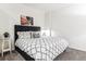 Modern bedroom features a padded headboard, neutral walls, and carpet at 2958 Syracuse St # 214, Denver, CO 80238